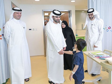 Sheikh Mansoor bin Mohammed bin Rashid Al Maktoum, Vice Chairman of the Dubai Health Board of Directors with a young patient at Al Jalila Children’s Hospital in Dubai on Monday