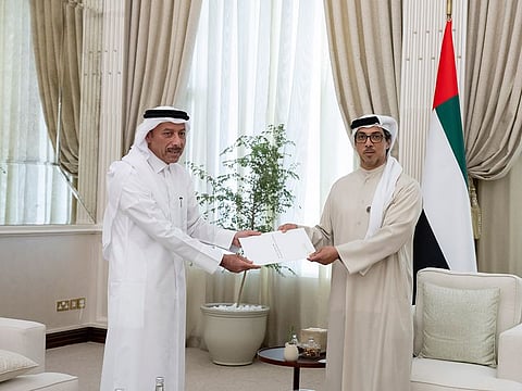 Sheikh Mansour bin Zayed Al Nahyan (right), Vice President, Deputy Prime Minister and Chairman of the Presidential Court, receiving the Qatari Emir's message from Sultan Al Mansouri, Ambassador of the State of Qatar to the UAE, at Qasr Al Bahr in Abu Dhabi on Tuesday