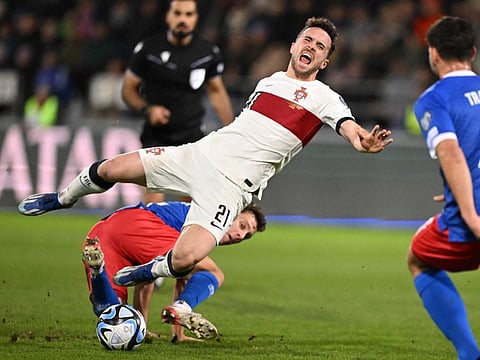 Portugals forward Diogo Jota (centre) is tackled by Liechtensteins midfielder Simon Luchinger during the Euro 2024 Group J on November 16.