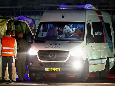 People who were taken hostage during the October 7 attack on Israel by the Palestinian militant group Hamas stand in a van after arriving in a helicopter amid a hostages-prisoners swap deal between Hamas and Israel, at Sheba Medical Center in Ramat Gan, Tel Aviv district, Israel.