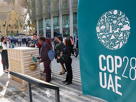 Delegates refill their water bottles at COP28 Blue Zone at the Expo City Dubai. Sustainability is a key theme at the UN climate conference and delegates were urged to use refillable water bottles.