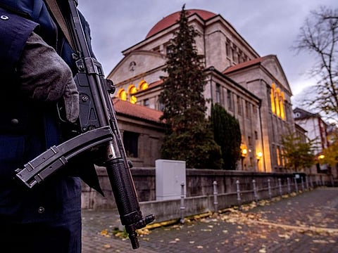 A German police officer stands guard in front of the synagogue in Frankfurt, Germany. Antisemitism is spiking across Europe after Hamas' October 7 massacre and Israel's bombardment of Gaza, worrying Jews.