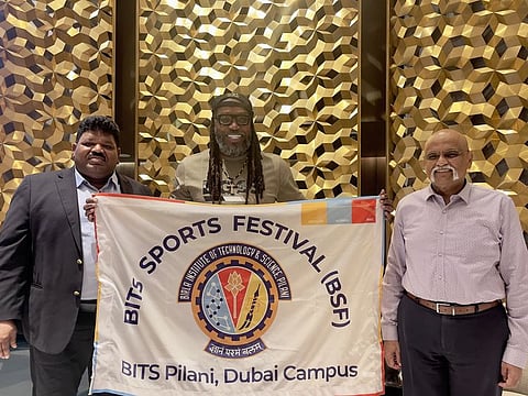 Legendary West Indian opener Chris Gayle holds the BITS Sports Festival logo along with Dr. Srinivasan Madapusi (right) and Dr. M. Rafiuddin.