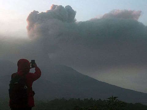 Volcanic ash spews from Mount Marapi during an eruption as seen from Lasi village in Agam, West Sumatra