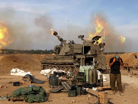 An Israeli army self-propelled artillery howitzer fires rounds from a position near the border with the Gaza Strip in southern Israel on December 7, 2023 amid battles between Israel and the Palestinian group Hamas in the Gaza Strip.