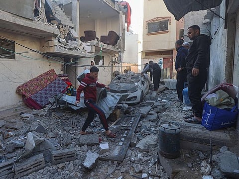 Palestinians inspect the rubble following Israeli bombardment on Khan Yunis in the southern Gaza Strip on December 8, 2023, amid continuing battles between Israel and the Palestinian militant group Hamas.