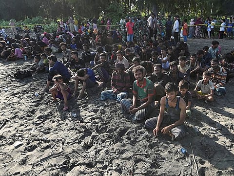 Rohingya Muslims rest on a beach after they land in Blang Raya, Pidie, Aceh province, Indonesia.