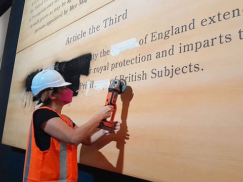 A protestor from the group defacing a historic exhibit at New Zealand’s National Museum, Te Papa, in Wellington.