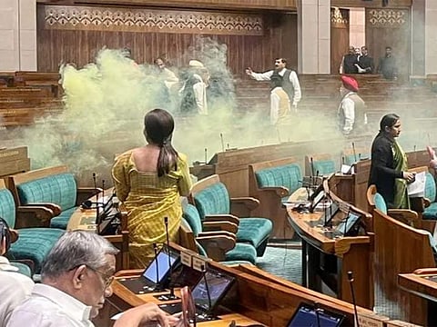 A man jumped into the lawmakers’ area of parliament, shouted slogans and set off a smoke can on the 22nd anniversary of a deadly attack on the complex.