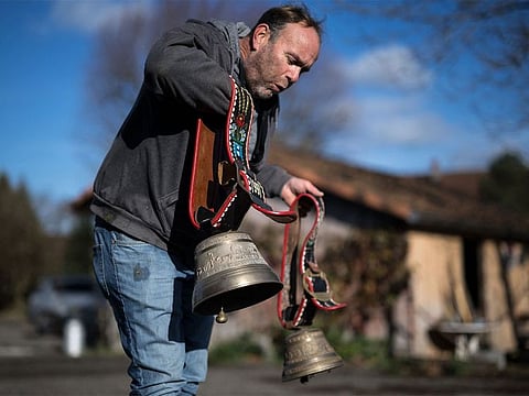 Farmer Rolf Rohrbach poses with cow bells in the village of Aarwangen, central Switzerland, on November 29, 2023.