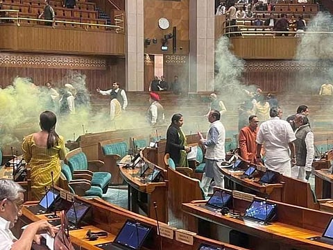 A smoke canister goes up inside the legislature