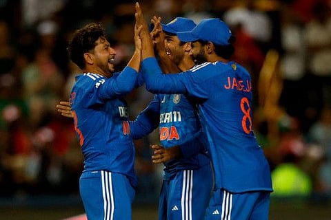 India's Kuldeep Yadav (left) celebrates with teammates after the dismissal of South Africa's Lizaad Williams (unseen) during the third T20 cricket match at the Wanderers Stadium in Johannesburg on Thursday.