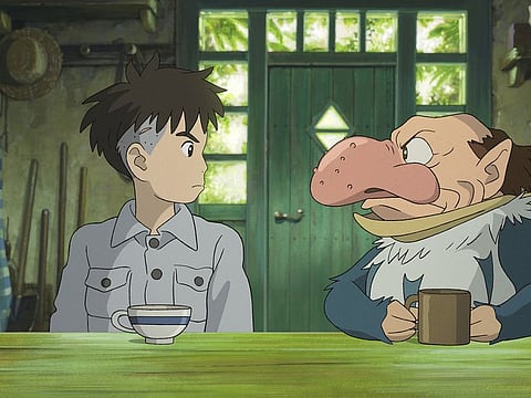This image released by GKIDS shows Mahito Maki, voiced by Luca Padovan in English and Soma Santoki in Japanese, left, and Grey Heron, voiced by Robert Pattinson in English and Masaki Suda in Japanese, in a scene from Hayao Miyazaki’s 'The Boy And The Heron.'