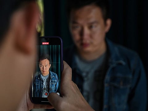 This photo shows Zhang Zewei, founder of AI firm Super Brain which specialises in digital replicas of the dead, has footage of him taken by a colleague as he demonstrates the creation of a video using artificial intelligence in Jiangyin, China's eastern Jiangsu province.