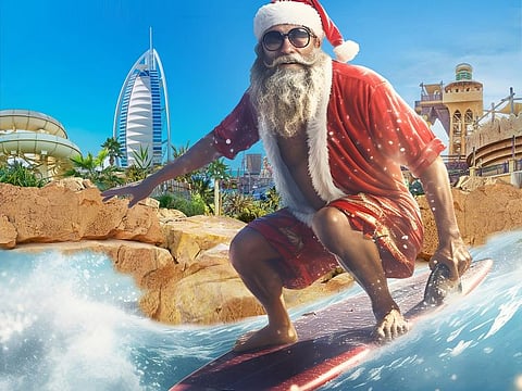 Surfing Santa, dressed in board shorts, will be conquering the wave rides daily at Flowrider