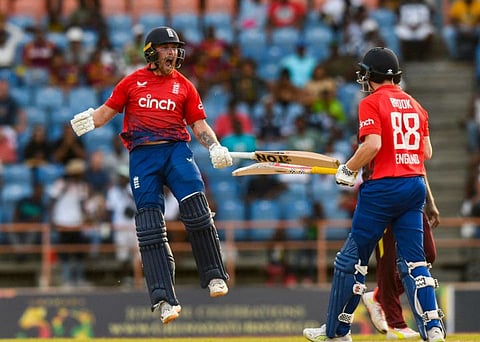 Phil Salt (left) and Harry Brook of England celebrate winning the 3rd T20I against West Indies at Grenada National Cricket Stadium, Saint George's, Grenada, on Saturday.