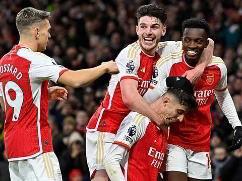 Arsenal's German midfielder Kai Havertz (centre) is mobbed by teammates after scoring the team's second goal during the English Premier League match against Arsenal at the Emirates Stadium in London on Sunday.