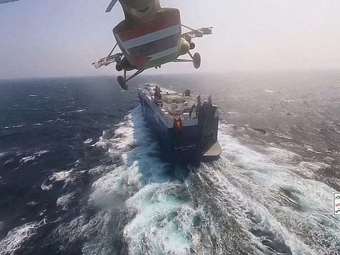 Al Houthi military helicopter flies over the Galaxy Leader cargo ship in the Red Sea in this photo released November 20, 2023.