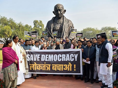 Opposition MPs in India including Sonia Gandhi, Mallikarjun Kharge, and Rahul Gandhi protest in front of the Gandhi statue against the suspension of 141 Opposition MPs for the Winter Session of Parliament, in New Delhi on Wednesday. (ANI Photo/Rahul Singh)