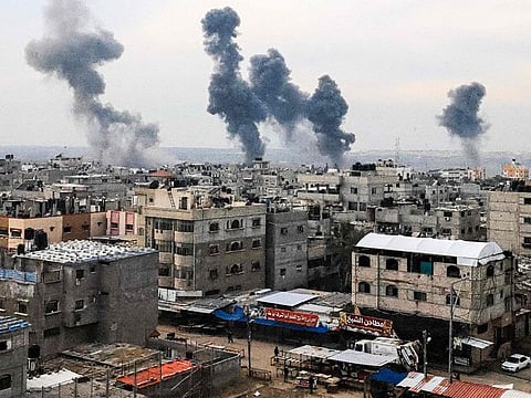A picture taken on December 20, 2023, from Rafah shows smoke billowing after Israeli strikes over the Nuseirat refugee camp in the central Gaza Strip, amid ongoing battles between Israel and the militant group Hamas.