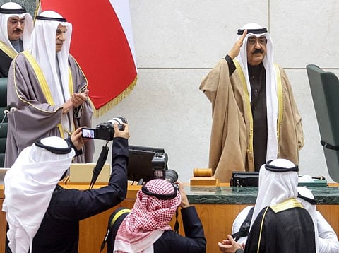 Sheikh Meshal salutes as he swears in before lawmakers as the country's 17th ruler, in the Kuwaiti parliament, on December 20, 2023.