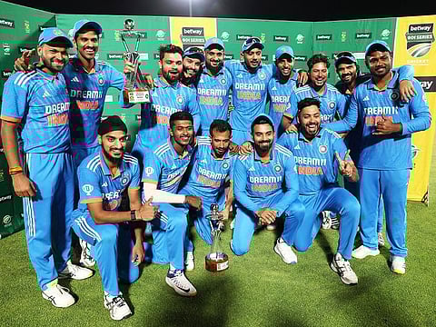 India players pose for a picture with the trophy as they celebrate winning the series against South Africa, in Boland Park, Paarl, on December 21, 2023.