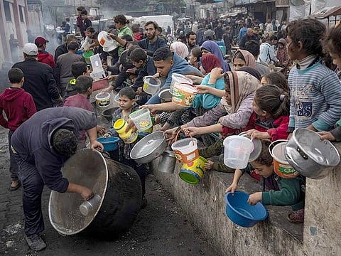 Palestinians line up for a free meal in Rafah, Gaza Strip. International aid agencies say Gaza is suffering from shortages of food, medicine and other basic supplies as a result of the two and a half month war between Israel and Hamas.