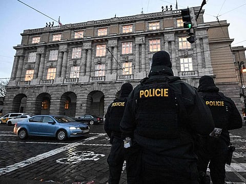 Police officers are seen in and around the Charles University in central Prague, on December 22, 2023, police investigators kept working on the campus the day after a deadly mass shooting.