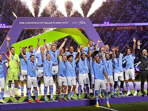 Manchester City's Kyle Walker lifts the trophy alongside teammates after winning the Club World Cup final.