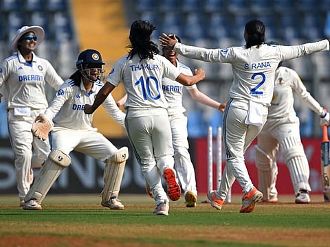 India's players celebrate after the dismissal of Australia's Alana King during the final day of the women's Test cricket match at the Wankhede Stadium in Mumbai on Sunday.