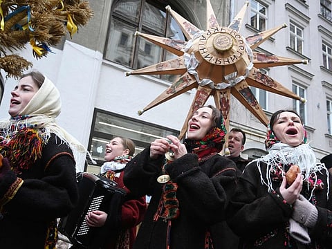 People sing carols as they take part in Christmas Eve celebration in Lviv, on December 24, 2023.