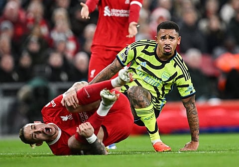 Liverpool's Greek defender Kostas Tsimikas reacts after being tackled by Arsenal's Brazilian striker Gabriel Jesus during the English Premier League match at Anfield in Liverpool.