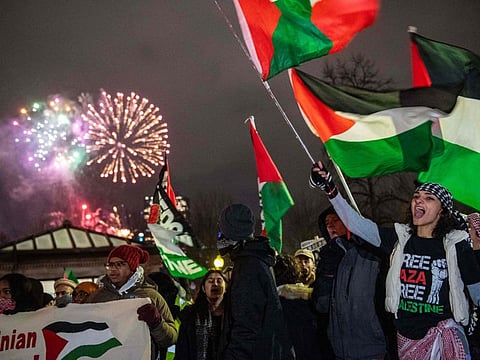 New Year's Eve fireworks go off in the sky as Palestinian supporters protest in Boston, Massachusetts, on December 31, 2023.
