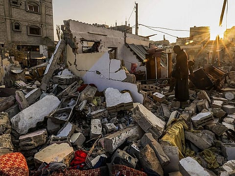 Residents search in the rubble of a house destroyed by Israeli bombardment in Rafah refugee camp, south of the Gaza Strip, on January 1, 2024, amid the ongoing conflict between Israel and the Palestinian militant group Hamas.