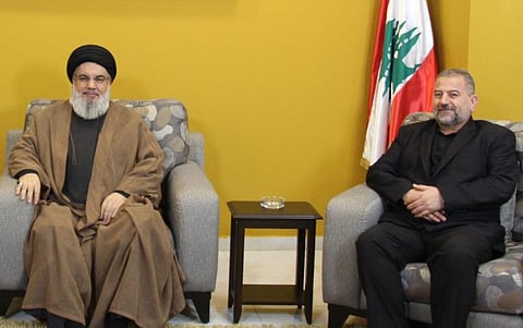 This September 2, 2023 picture shows Hezbollah chief Hassan Nasrallah (left) during a meeting with the deputy chief of the Palestinian Hamas movement, Saleh Al Aruri, at an undisclosed location in Lebanon.