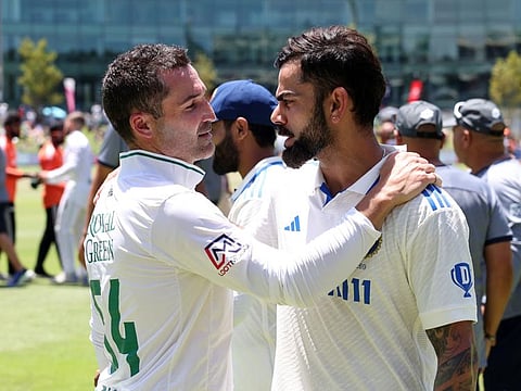 South Africa's Dean Elgar with India's Virat Kohli at the Newlands Cricket Ground in Cape Town on Thursday.