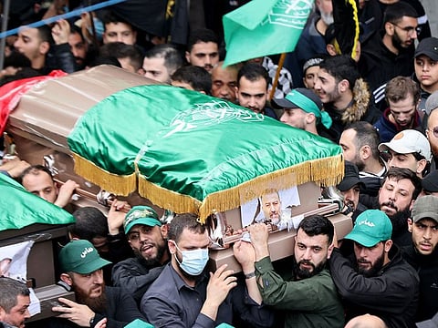 Mourners carry the coffin of Hamas' deputy leader Saleh Al Aruri.