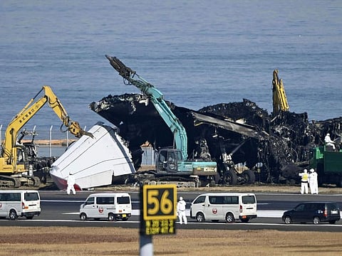 A removal work is underway at the site of a planes collision at Haneda airport in Tokyo Friday, Jan. 5, 2024.