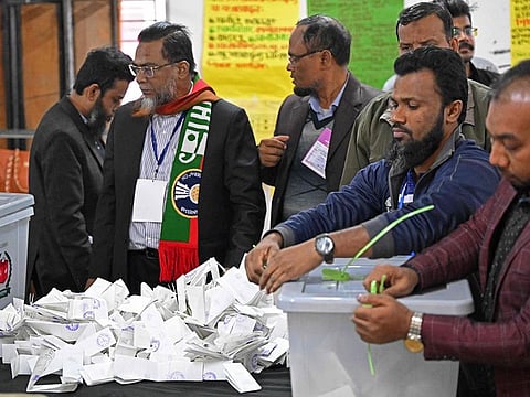 Election officials prepare to count votes in Dhaka.
