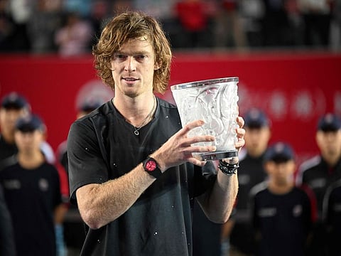 Russias Andrey Rublev with the trophy after winning the final against Finlands Emil Ruusuvuori at the Hong Kong Tennis Open in Hong Kong on Sunday.)