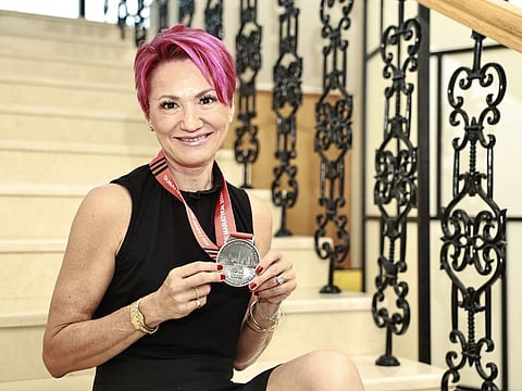 Laura Everest showing off her medal after completing the 10km race in 63 minutes in the Dubai Marathon.