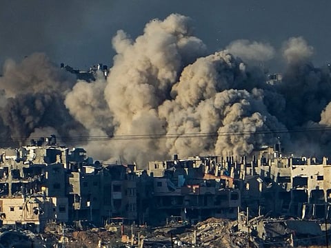 Smoke rises following an Israeli bombardment in the Gaza Strip on December 16, 2023. Israel is sending top legal minds, including a Holocaust survivor, to The Hague on Thursday to counter allegations that it is committing genocide against Palestinians in Gaza.