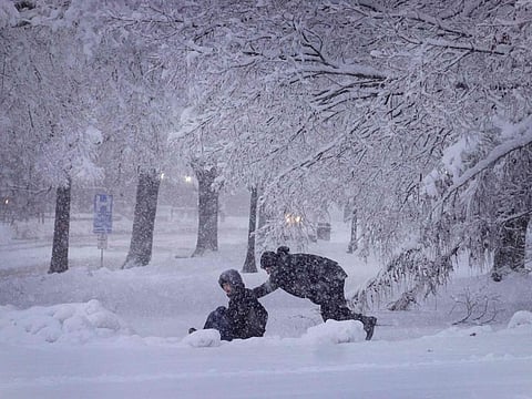 Students play on the campus of the University of Iowa on January 09, 2024 in Iowa City. A record-breaking cold threatens to complicate Iowa's leadoff caucuses as snowy weather cancels events.
