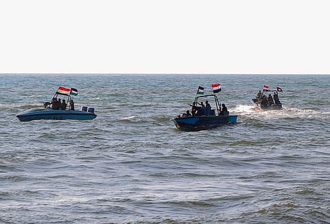 Members of the Yemeni Coast Guard affiliated with Al Houthi group patrol the sea as demonstrators march through the Red Sea port city of Hodeida.