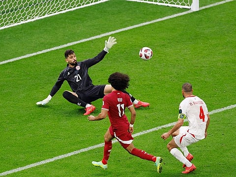 Qatar's forward #11 Akram Afif scores his team's third goal during the AFC Asian Cup Group A football match against Lebanon at the Lusail Stadium in Lusail, north of Doha on January 12, 2024.