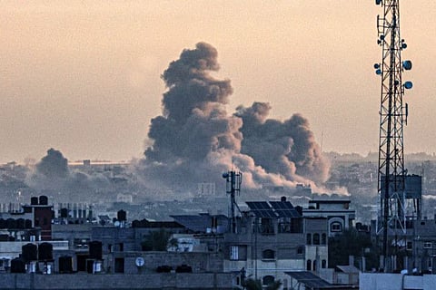 Smoke billows over Khan Younis in the southern Gaza Strip during Israeli bombardment, as the war between Israel and the Palestinian militant group Hamas enters its 100th day on January 14, 2024.