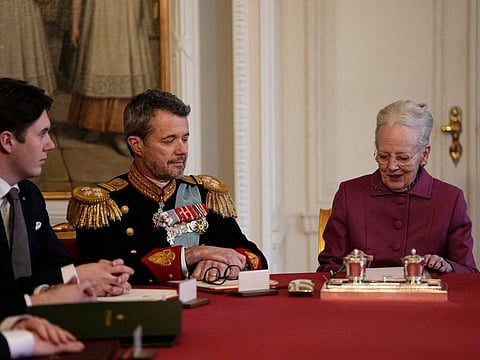 Queen Margrethe II of Denmark signs a declaration of abdication as Crown Prince Frederik and Prince Christian look on in the Council of State at the Christiansborg Castle in Copenhagen on January 14, 2024.