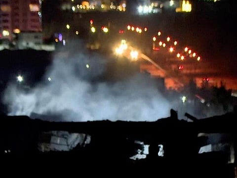 This image taken from video provided by Rudaw TV shows smoke rising from a building hit by a strike in Irbil, Iraq, on Tuesday, January 16, 2024.