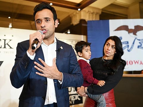 Republican presidential candidate and businessman Vivek Ramaswamy speaks to supporters as he stands with his wife Apoorva Tewari and son Karthik at his Iowa caucus night watch party after suspending his campaign and endorsing former US President Donald Trump in Des Moines, Iowa, on January 15, 2024.
