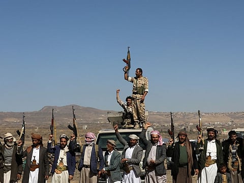 Al Houthi militants and their tribal supporters hold up their firearms during a protest against recent US-led strikes on Al Houthi targets, near Sana'a, Yemen, on January 14, 2024.